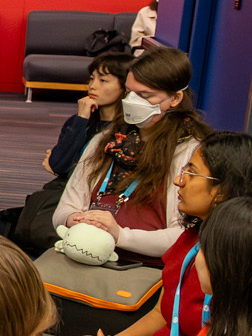 us at a round table at an angle that looks like our eyes are closed. we have an orange-and-grey laptop bag in our lap with a plush green lizard sitting on top of it facing the camera so that only its big snoot is visible
we have a white cardigan, a red shirt, a black-and-pink scarf, and an N95 mask on us at a round table at an angle that looks like our eyes are closed. we have an orange-and-grey laptop bag in our lap with a plush green lizard sitting on top of it facing the camera so that only its big snoot is visible
we have a white cardigan, a red shirt, a black-and-pink scarf, and an N95 mask on